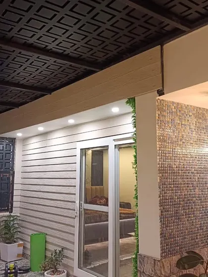 Another angle of the completed Najafgarh site, showing the detailed textures of the pergola roof, wall cladding, and mosaic tiles.