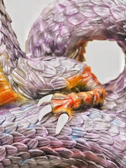 The detail on the dragon's claw. In my sculpting classes, I teach how to create these fine details, from the texture of the skin to the sharpness of the claws, to make your creations look real.