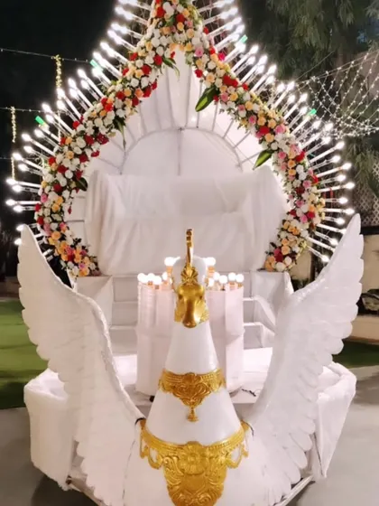 For a truly unique bride and groom entry, I designed this magnificent winged peacock chariot. This custom structure, complete with intricate lighting and floral details, ensures your arrival is a spectacular and memorable part of the celebration.