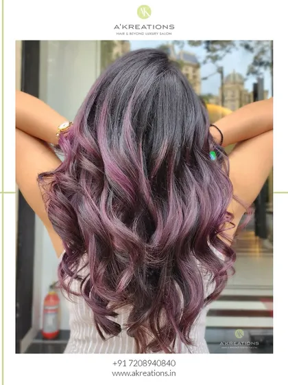 A back view of the purple highlights, styled into soft waves to show off the beautiful blend of colors.