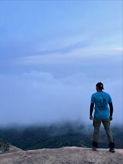 One of our trek leaders overlooking a misty valley. These are the breathtaking views we help your team discover on our guided corporate treks.