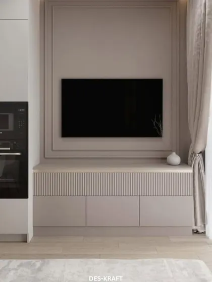 A minimalist TV unit with fluted cabinet doors and an integrated appliance garage, demonstrating our knack for creating clean, functional entertainment spaces.