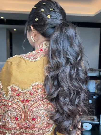 Another view of the golden coin ponytail, a creative and stylish choice for a modern bride.