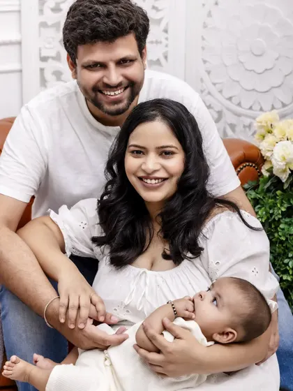 A classic family of three portrait. This image showcases a happy, relaxed family looking directly at the camera, creating a picture perfect memory for their home.