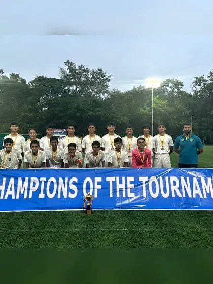 The team celebrating with their "Champions of the Tournament" banner after winning the CISCE U-19 regionals.