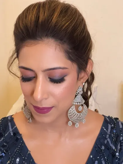A close-up on the finished eye makeup. The blend of pink and purple tones is modern and fun, a great style to have in your repertoire for younger clients or sangeet events.