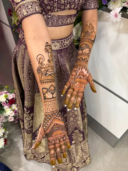 A stunning bridal mehandi featuring portraits of Radha and Krishna. The divine figures are complemented by swan motifs and intricate patterns, creating a truly blessed design.