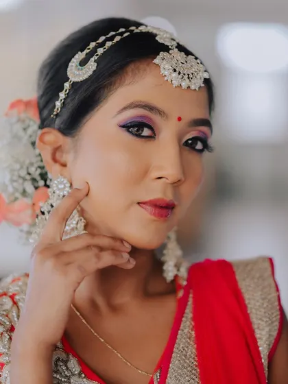 This portrait showcases the beautiful floral arrangement in the bride's hair, along with her elegant earrings and makeup. It highlights how every element comes together.