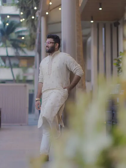 A relaxed and stylish portrait of the groom in a simple kurta, taken during one of the pre-wedding events.