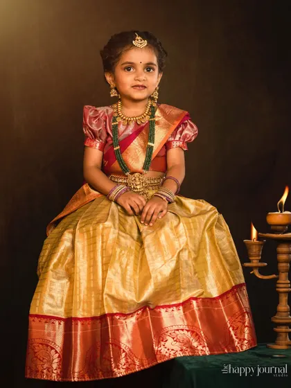 A full-length portrait of a girl in a traditional silk lehenga, her pose and expression full of grace and poise.