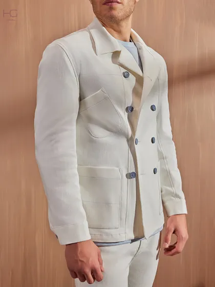 A side profile of the white denim-on-denim look, emphasizing the clean lines and modern silhouette of the double-breasted shacket.