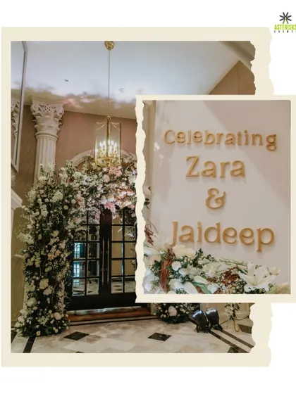 A grand and elegant entrance for a wedding reception. The doorway was framed with a massive arch of white flowers, creating a stunning first impression for guests.