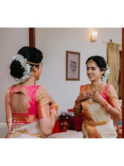 The bride admiring her final look in the mirror.