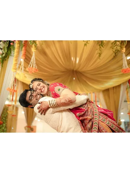 A joyful dip! The groom dips his bride for a fun, dynamic, and happy portrait under a beautifully decorated mandap.