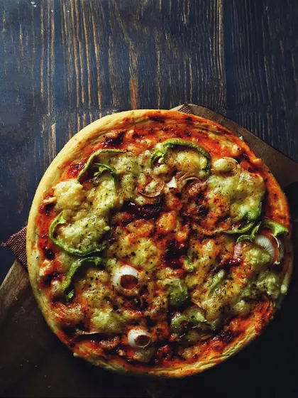 A top-down view of the pizza, showcasing all the toppings. This flatlay perspective is great for menu shots or for food bloggers sharing a recipe.