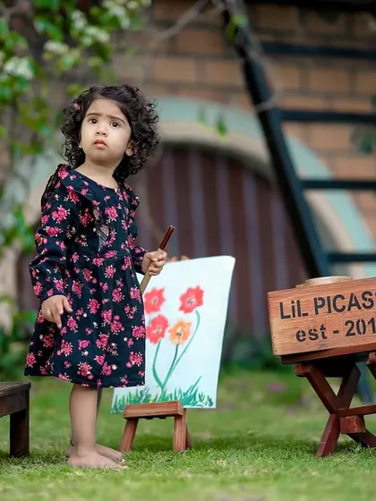 A budding artist at work in our garden. The 'Lil Picasso' theme is one of our most popular and creative outdoor setups.