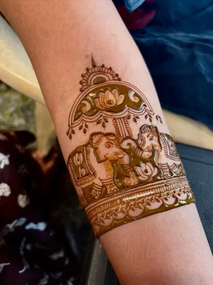 A detailed shot of an arm band featuring the Ambari elephant, a classic and regal motif for any bride.