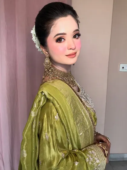 A side profile showing the elegant hairstyle and the way the dupatta drapes.