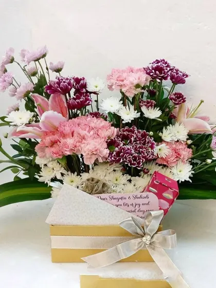 A lovely flower box for Mom. This arrangement of pink carnations, lilies, and chrysanthemums is a simple yet beautiful way to show your love and appreciation.