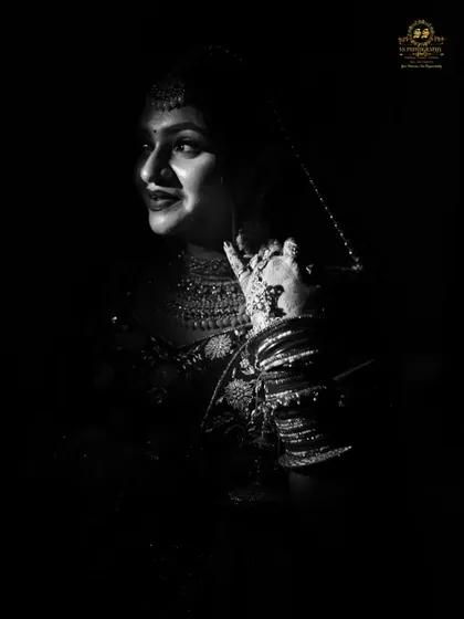 A low-key, black and white portrait that creates a sense of intimacy and elegance. This style uses shadows and light to beautifully highlight the bride's features and expression.
