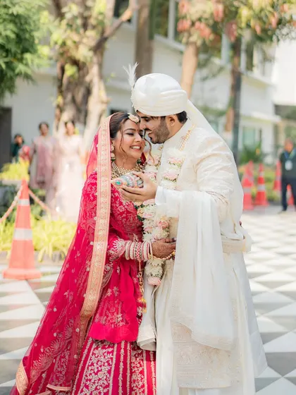 A sweet, intimate moment between the bride and groom. Shikha's makeup looks soft and romantic, perfect for these candid shots.