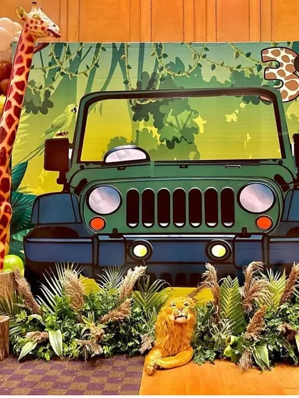 The safari jeep photo booth from another angle, showing the detailed jungle backdrop and animal props. The setup is designed to be interactive and fun for all the little adventurers.