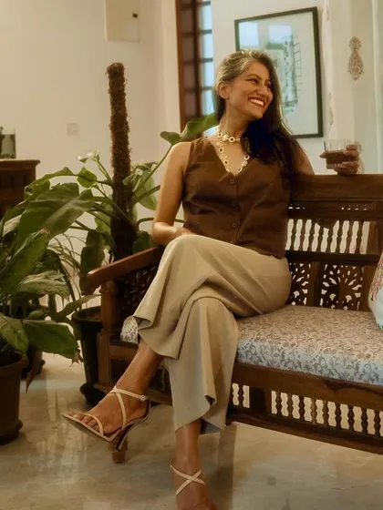 This pose shows how the neutral tones of the waistcoat and trousers create a sophisticated and cohesive look.