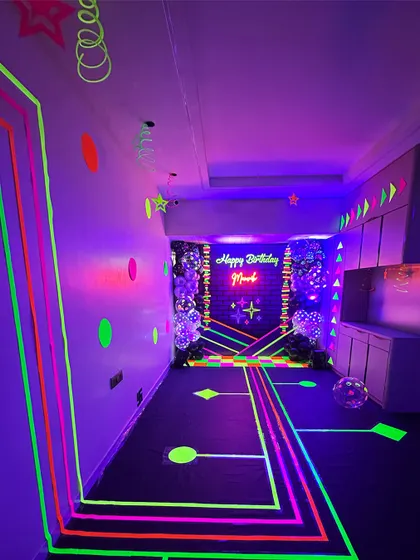I transformed this entire hallway into a neon wonderland. Using fluorescent tape, I created a glowing pathway leading to the main party area, building excitement from the moment guests arrived.