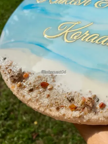 A close-up detail of the 3D ocean nameplate, showing the texture of the real sand and shells embedded in the resin. This is how I create a realistic shoreline effect.