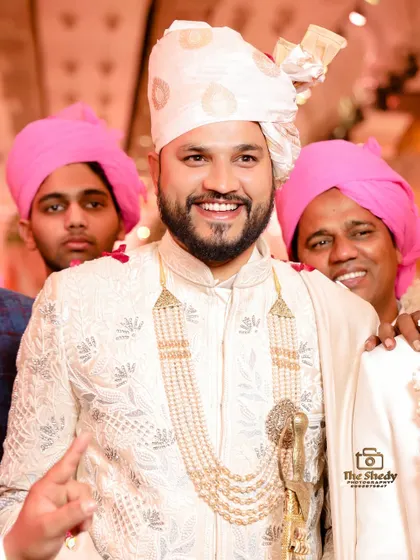 The groom surrounded by his family and friends, all sharing in his happiness. These are the moments of love and support we love to capture.