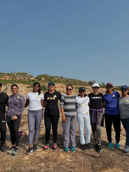 Another group photo on a rocky plateau, showcasing the typical terrain of treks around Bangalore. We help you find the best spots for those perfect team pictures.