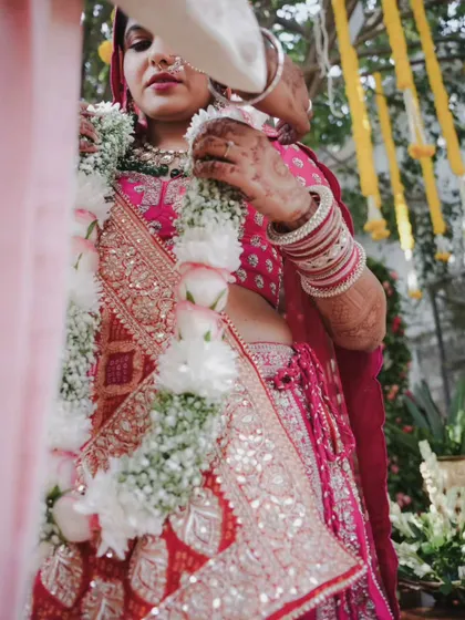 A close-up of a bride during a wedding ritual, her expression a mix of emotion and concentration.