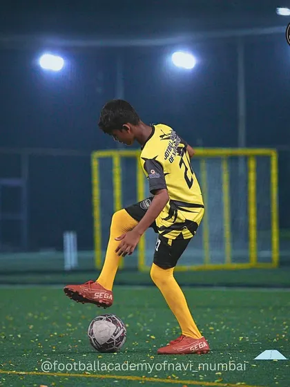 A player practices a foot-on-ball stance, a key part of developing balance and mastery over the ball.