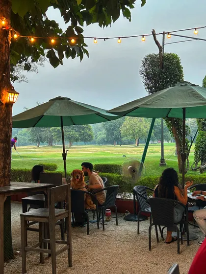 A couple enjoys a quiet moment at the cafe with their furry friend, showing the relaxed and inclusive atmosphere we cultivate for all our guests.