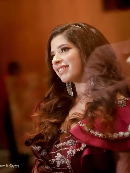 A joyful, candid portrait of the bride. Her bright smile and the soft, dreamy lens flare create a magical and happy moment.