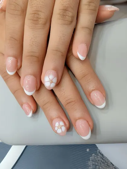 When you want something timeless yet playful. This classic French manicure gets a fresh update with delicate, hand-painted floral accent nails.