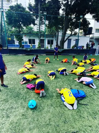 Players cool down with stretches after a session. We teach the importance of proper warm-ups and cool-downs for injury prevention.