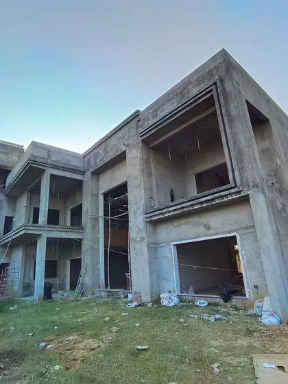 Another angle of the Moradabad villa during construction, showcasing the large openings and the interplay of different structural volumes that will define the home's character.