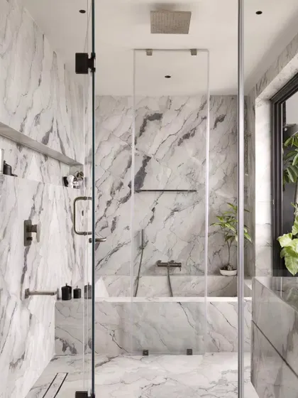 The view from the vanity into the shower area. The frameless glass keeps the space feeling open and light-filled.