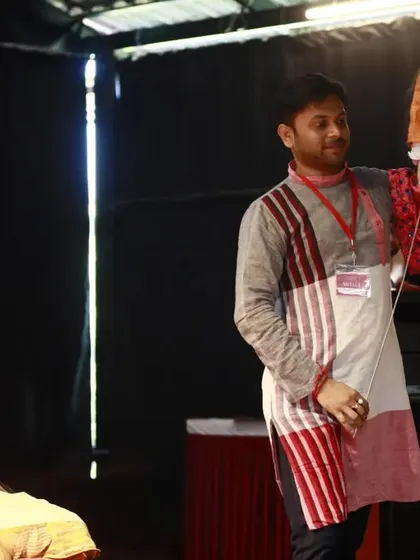 A closer look at the rod puppet demonstration by Dr. Subho Joardar. You can see the intricate connection between the puppeteer's hand and the puppet's expressive gestures.