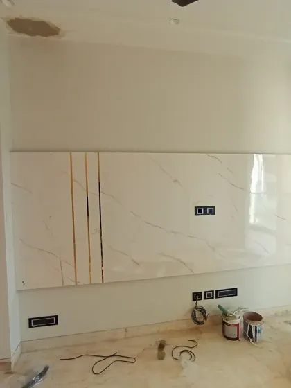 The TV panel during installation, showing the raw materials before the final finishes are applied.