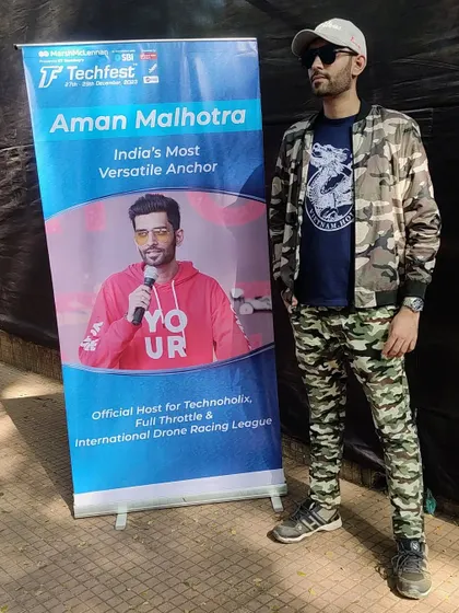 Rocking a camo look for one of the days at Techfest, standing next to my official host banner.
