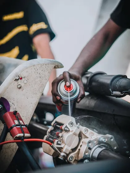 A mechanic servicing a kart's brake system.