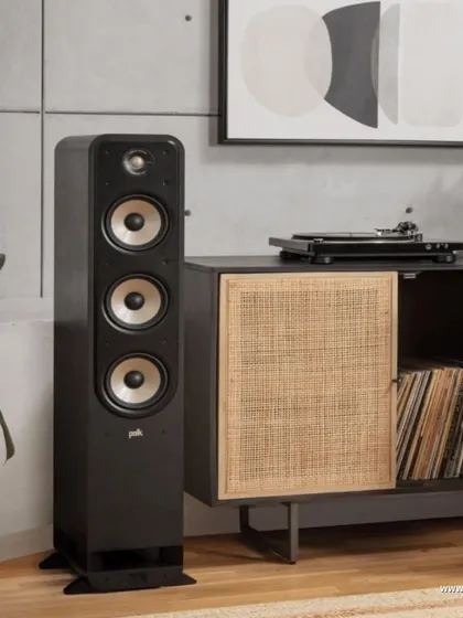 The Polk Signature Elite ES60 tower speaker, shown here next to a turntable setup. This speaker is part of a series designed to bring rich, detailed sound to every corner of your home.