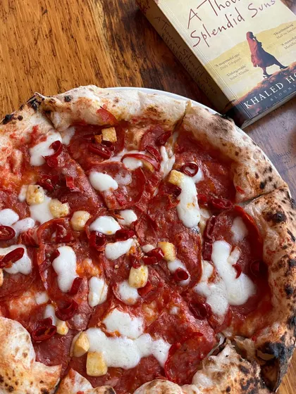 Another perfect pairing: a spicy pepperoni pizza and a compelling novel.