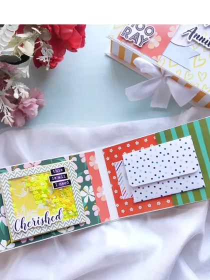 This page features a "Cherished" shaker window and two small envelopes for secret notes or tiny keepsakes.