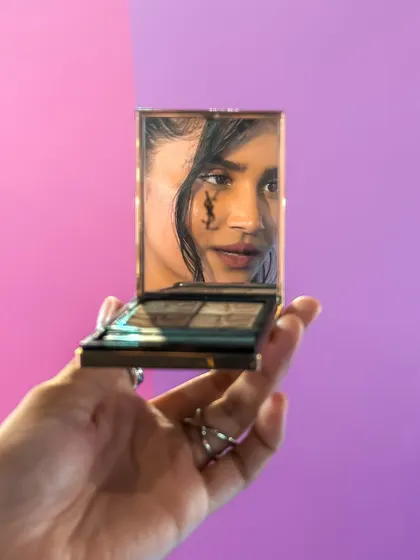 A creative shot using a compact mirror to reflect my makeup at the YSL Beauty Light Club Party.