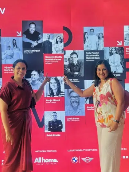 Our team members proudly pointing to their names on the 'Design POV' feature wall. It's always a proud moment to see our people and our work recognized.