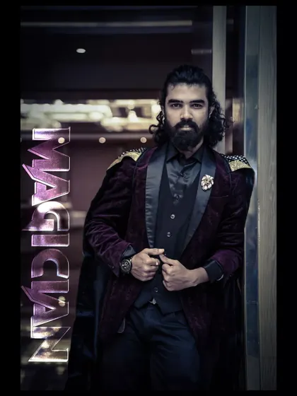 A portrait that channels the classic, mysterious magician. This look, with the velvet jacket and confident gaze, is all about the art of illusion.