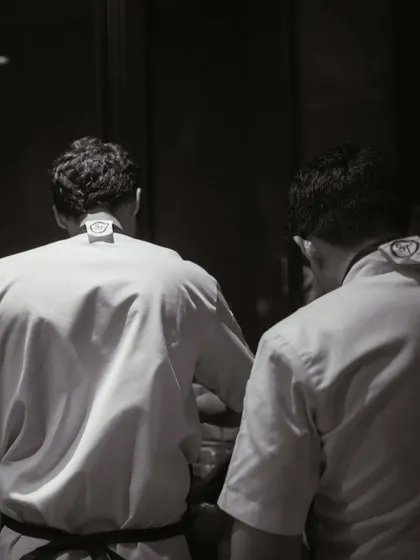 A black and white shot of my chefs working side-by-side, showcasing the collaboration and dedication of my team.